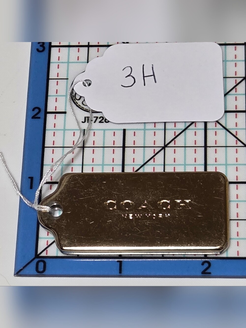 COACH Gold Metal Logo Plate